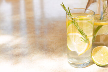 Tasty refreshing lemonade and ingredients on light table, space for text. Summer drink