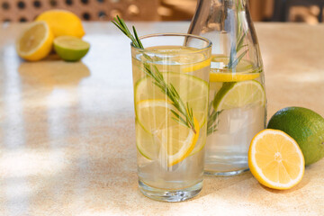 Summer refreshing lemonade on light table in cafe, space for text