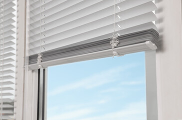 Stylish window with horizontal blinds, closeup view