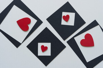 paper box with squares and wooden hearts painted red