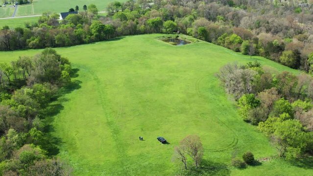 Aerial View Of  Evergreen Field With Land Surveyors Near Siloam Springs Countryside In Arkansas, USA. Aerial Drone Shot