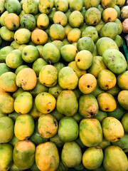 A collection of ripe mangoes on display at the market.