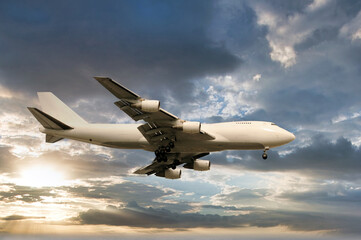 Jumbo jet landing in twilight - 533066381
