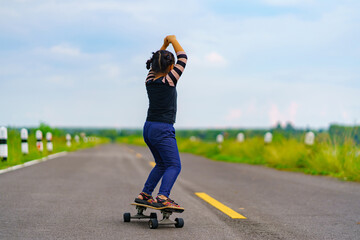 Child or kid girl playing surfskate or skateboard in skating rink or sports park at parking - 533073354