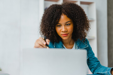 Young african american female worker working on company marketing report and analyzing statistic research at office workplace, start up on new company concept.