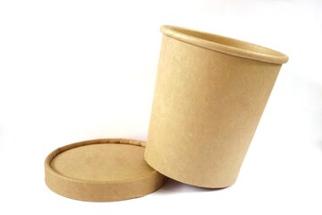 A glass made of paper separated from the lid on a white background.