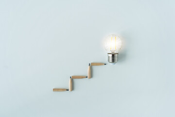 Bright or glowing lightbulb with pencil. Success idea conceptual of business growth and education...