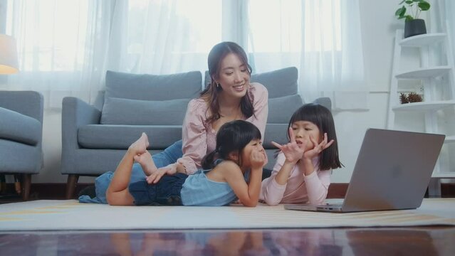 Asian family with children using laptop computer at home