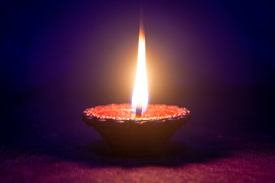 Happy Diwali - Clay diya lamp lit during diwali celebration