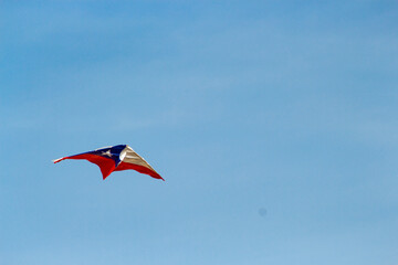 Fototapeta na wymiar kite in the shape of the Chilean flag on a blue background