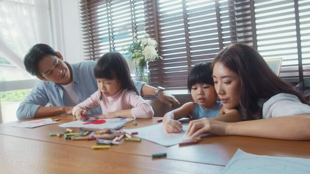 Asian family with children Drawing and painting on table in playing room at home, Educational game.