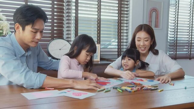 Asian family with children Drawing and painting on table in playing room at home, Educational game.
