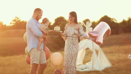 child's lifestyle. happy birthday in autumn field at sunset little kid in tent with cake. photographer shoots a birthday. family and baby joy.