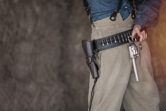 Close up gun in hand of cowgirl.  close up gun in theme cowboys concept.