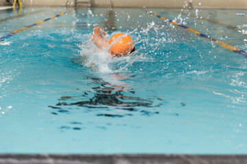 Swimming - male swimmer, man in indoor pool