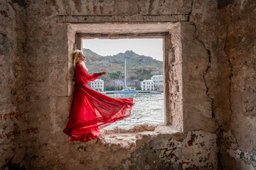 View of Balaklava Bay through an arched balcony in oriental style. The girl in a long red dress...