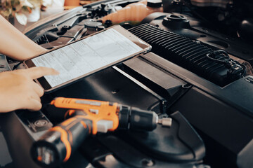 Automobile mechanic repairman hands repairing a car engine automotive workshop