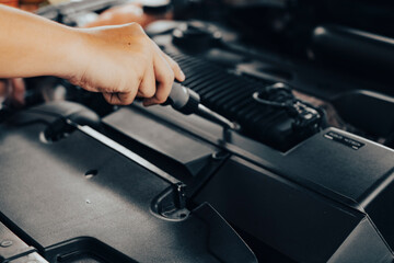 Automobile mechanic repairman hands repairing a car engine automotive workshop