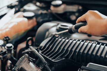 Automobile mechanic repairman hands repairing a car engine automotive workshop