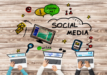 Top view of businesspeople sitting at table and using gadgets
