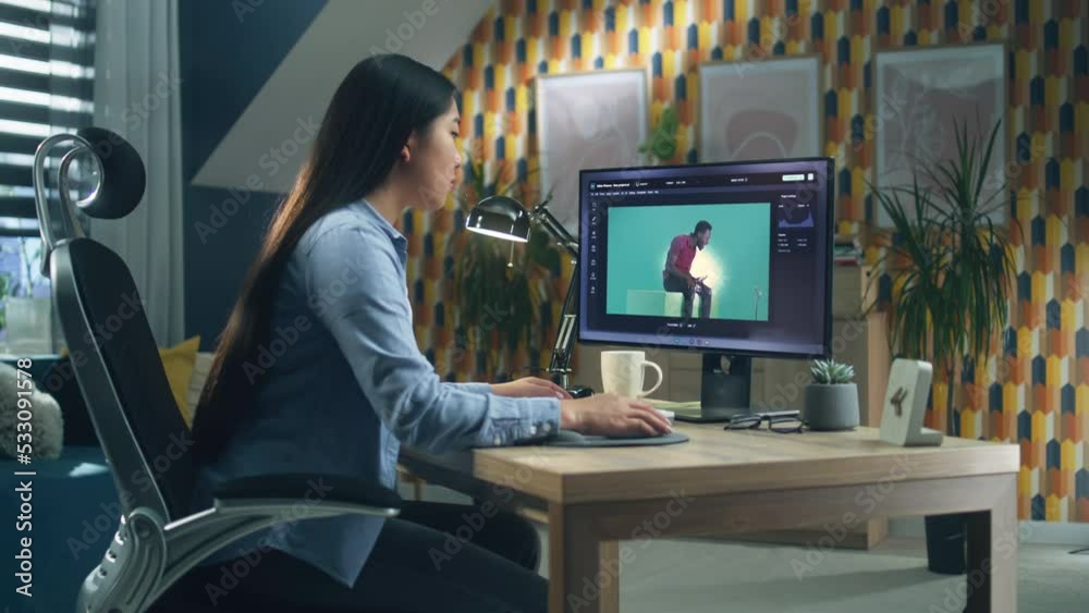 Canvas Prints asian woman editing photo in photoshop for customer on personal computer while sitting at the table 