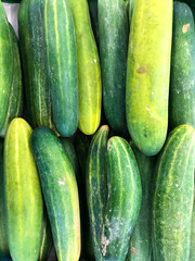 Pile of cucumbers in supermarket for vegetable background.