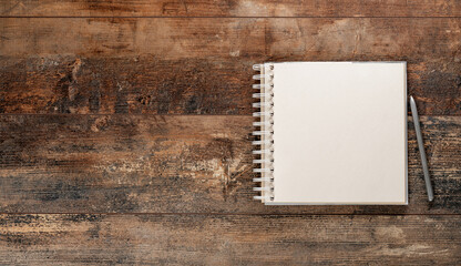 Mockup blank notebook and pen on old rustic wooden table. top view. copy space. Art, craft,...