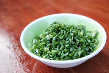 spring onions shuffled  in a bowl