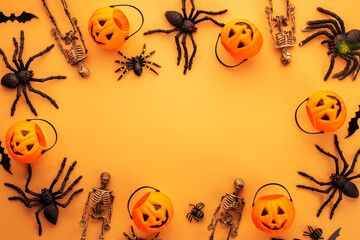Halloween decorations, pumpkins, skeletons, bats, spiders on orange background