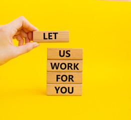 Let us work for you symbol. Wooden blocks with words Let us work for you. Beautiful yellow...