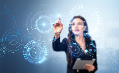 Businesswoman wearing formal wear touching digital interface with circle hologram