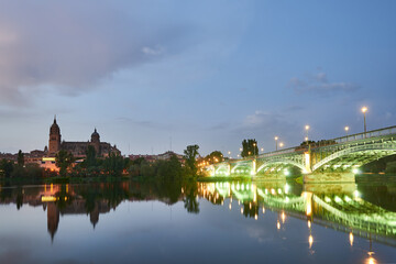 Fototapeta na wymiar Cathedral of Salamanca at night and Enrique Esteban Bridge view