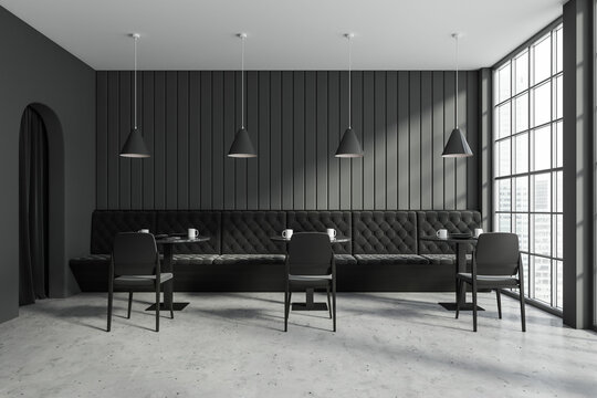 Grey cafe interior with couch and chairs with table, panoramic window