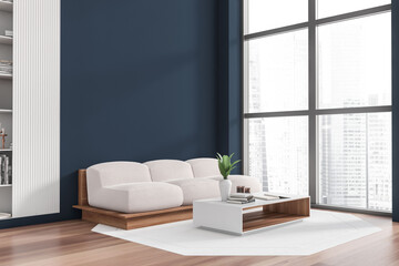 Bright living room interior with empty blue wall, sofa