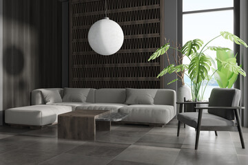 Grey chill interior with couch and armchair with plant near panoramic window