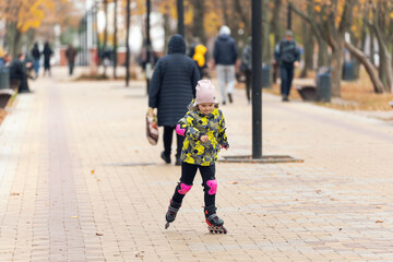 Cute little girl learning to roller skate