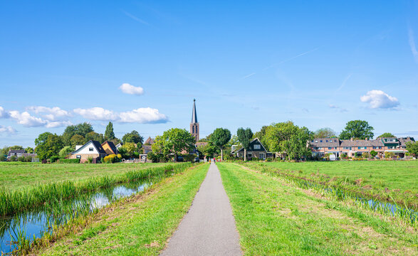 Bicycle path in the Dutch countryside, leading to neighbourhood Zuidbuurt, part of the village of Zoeterwoude-Dorp, The Netherlands.