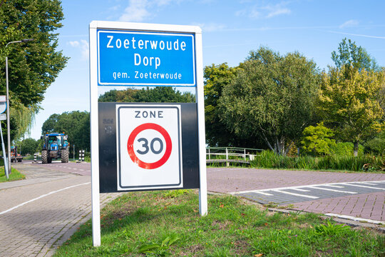 Place name sign of the village of Zoeterwoude-Dorp, municpality of Zoeterwoude. Board below means that in that zone the speed limit is 30.