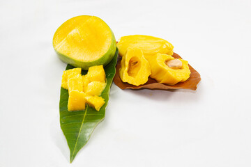 Jackfruit And Mango cut on leaves. tropical summer fruits in Asia. isolated studio photo. refreshing hot day fruit salad.