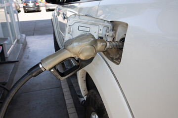 Nozzles in the gas station. A diesel dispenser that is filling up with a car that stops for fuel during the trip.