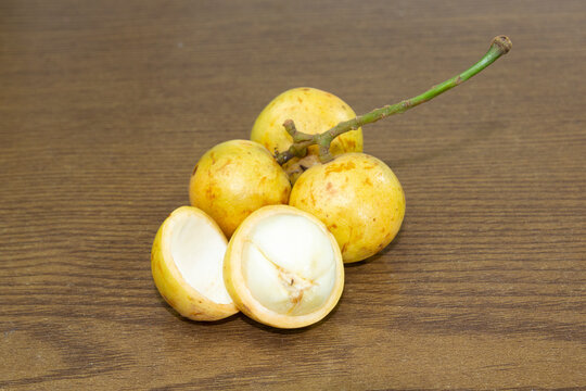 Baccaurea motleyana also known as lotkon isolate on wooden background. sweet and sour taste.