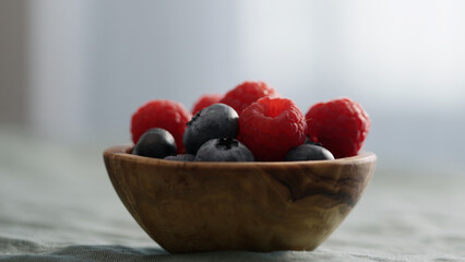 Fresh berries in bowl on linen napkin