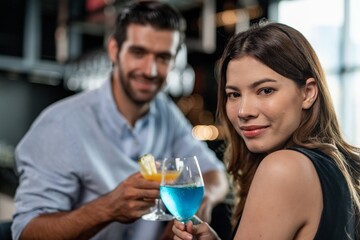 Portrait photo of a couple having a good time together drinking cocktail in a sky lounge and bar in Bangkok city