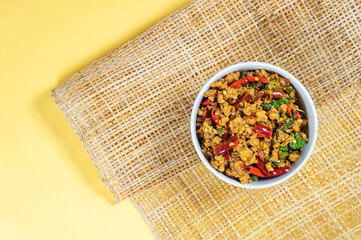 Top view of Stir-fried basil with minced pork hot and spicy taste serving on a table,Thai famous food, Hot and spicy food concept.