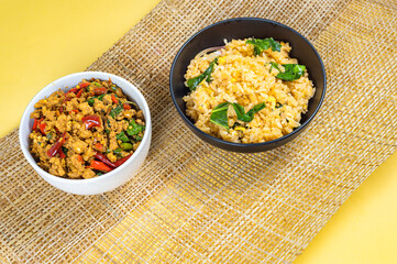 Top-view of Fried Rice in black bowl and Stir-fried basil with minced pork hot and spicy taste serving together,Thai famous food, Hot and spicy food concept, Combo set for eatting.  