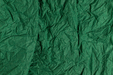 Green crumpled paper background. Full frame texture.