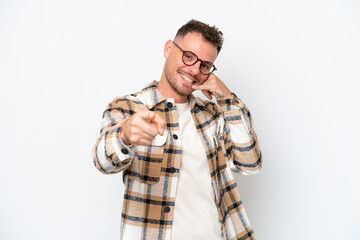 Young caucasian handsome man isolated on white background making phone gesture and pointing front