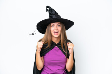 Young caucasian woman costume as witch isolated on white background celebrating a victory in winner position