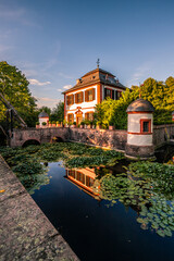 Historical sight, moated castle at sunset, reflection in the pond, Klein-Welzheim, Seligenstadt, Hesse, Germany