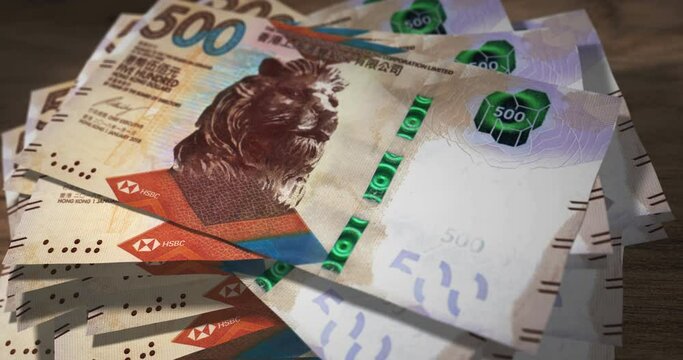Hong Kong Dollar 500 HKD banknotes falling on the table. Hong Kong currency paper notes count on stack. Timelapse of money counting. 3D concept.